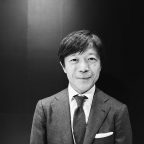 Kazuto Yamaki, CEO of Sigma, pictured at the 2018 CP+ show in Yokohama, Japan. - DPReview